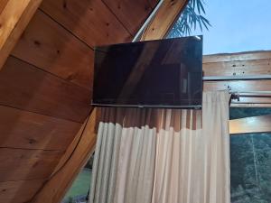 a tv on the wall of a house with a window at Alpinas El chical in Guazacapán