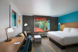 a hotel room with a bed and a desk and a desk at TownePlace Suites Lubbock in Lubbock