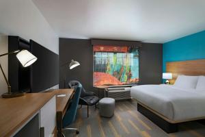 a hotel room with a bed and a desk and a window at TownePlace Suites Lubbock in Lubbock +17 photos