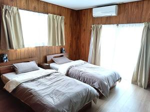Postel nebo postele na pokoji v ubytování させぼ旅の宿KawashimoEn