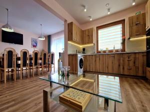 cocina con mesa de cristal y comedor en Holiday Home in Wi niowa with Pool and Forest, en Iwierzyce