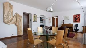 a dining room with a glass table and chairs at Italianway-Benedetto Marcello in Milan