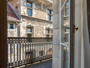 a view of a building from a balcony at Appartement charmant au cœur de Vesoul avec parking privé - FR-1-583-509 in Vesoul