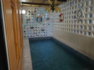 a hallway with a pool of water in a room at Minimal Pool Villa Chiang Mai in Chiang Mai