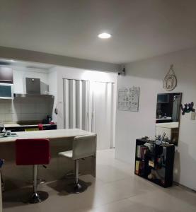 a kitchen with a table and two chairs in a room at Habitación en apartamento compartido frente a Maiquetía! in Maiquetía