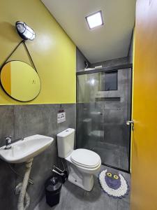 a bathroom with a toilet and a sink and a shower at Hostel GomaPass Guarulhos Aeroporto in Guarulhos +14 photos