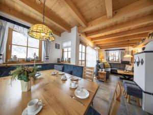 a dining room and living room with a wooden ceiling at Chalet in Königsleiten near Ski Lift in Wald im Pinzgau