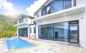 a house with a swimming pool in front of it at Cheongdo Nurifull House in Cheongdo