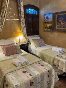 a room with three beds with blankets on them at Haras de Charme in Guillermo E. Hudson