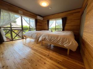 Ένα ή περισσότερα κρεβάτια σε δωμάτιο στο 湯布院 温泉付きの貸切別荘 無料Wi-Fi 無料駐車場