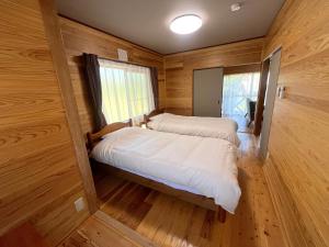 Ένα ή περισσότερα κρεβάτια σε δωμάτιο στο 湯布院 温泉付きの貸切別荘 無料Wi-Fi 無料駐車場