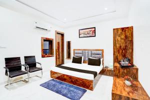 a bedroom with a bed and a chair at Townhouse Narholi Bridge Mathura in Mathura