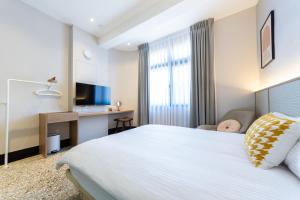 Ένα ή περισσότερα κρεβάτια σε δωμάτιο στο 小蒔光民宿