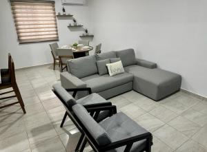 a living room with a couch and chairs and a table at Haven de descanso y relajación in Puerto Morelos