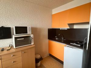 a small kitchen with a sink and a microwave at Studio à Super Besse avec vue sur pistes et balcon - FR-1-814-16 in Besse-et-Saint-Anastaise