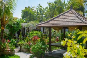 a gazebo in the middle of a garden at Muaya Villa in Jimbaran