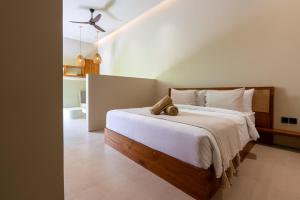 a bedroom with a bed with a teddy bear on it at Casa Komang, lovely studio in central Bingin in Uluwatu