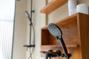 a black hair brush in a wooden holder at Casa Komang, lovely studio in central Bingin in Uluwatu