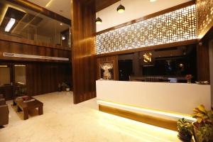 a lobby of a hotel with a reception desk at Jivanta Shirdi in Shirdi
