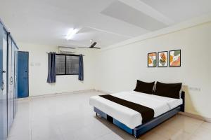 a bedroom with a bed in a room at Hotel O Talawade IT Park Formerly AR Rooms in Dehu