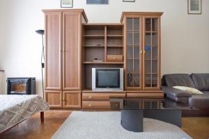 a living room with a tv and a entertainment center at Apartments Bolshaya Konushennaya 1 in Saint Petersburg