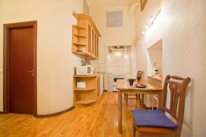 a kitchen with a table and chairs and a microwave at Apartments Bolshaya Konushennaya 1 in Saint Petersburg