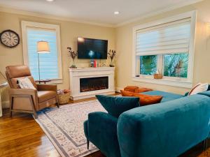 a living room with a blue couch and a fireplace at Sound to Shore - 1930s Tudor - Private Pool in Aransas Pass
