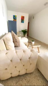 a living room with a white couch and a table at Casa Hemma in Santa Marta