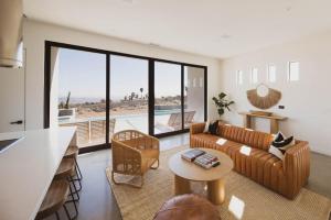 a living room with a couch and a table at White Casita by Fieldtrip - Modern w Pool Spa in Joshua Tree