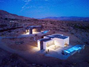 an aerial view of a house in the desert at night at White Casita by Fieldtrip - Modern w Pool Spa in Joshua Tree