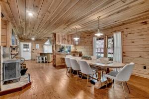 a kitchen and dining room with a table and chairs at Church Farm Cabin in Pell City