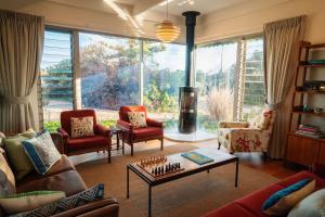 a living room with a couch and chairs and a table at Chiton Cottage by the Sea - Restaurants, Bikes, Pets in Hayborough