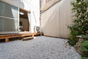 a patio with a bench next to a building at 三十三Inari in Kyoto