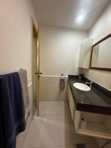 a white bathroom with a sink and a mirror at Copacabana Front beach 2 in Rio de Janeiro