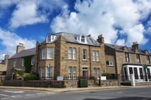 a large brick building on the side of a street at Eddlewood Guest House in Lerwick