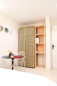 a room with a table and a book shelf at Palette Room, Design House in Lekki