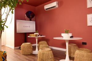 a waiting room with two tables and stools at Palette Room, Design House in Lekki