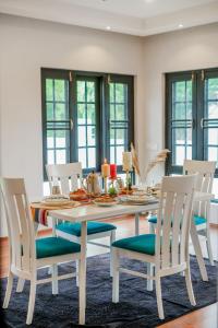 a dining room with a white table and chairs at Badakshan Bliss in Srinagar