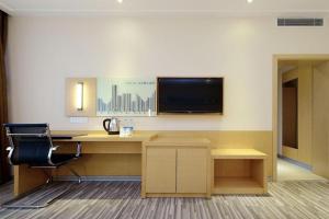 an office with a desk and a chair and a television at City Comfort Inn Tongren High-speed Railway Station in Tongren