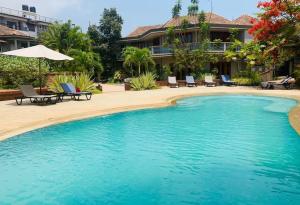 a swimming pool in front of a house at Argo by Trance in Dabolim