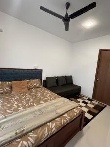 a bedroom with a bed and a couch at Beautiful and Cozy 1BHK in Thane in Thane