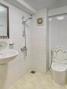 a bathroom with a toilet and a sink at Haha House - Studio near Ben Thanh Market in Ho Chi Minh City