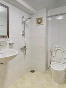a bathroom with a toilet and a sink at Haha House - Studio near Ben Thanh Market in Ho Chi Minh City