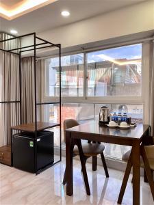 a dining room with a table and a large window at Haha House - Studio near Ben Thanh Market in Ho Chi Minh City