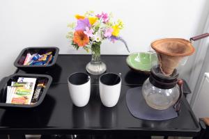 a black table with flowers and a vase on it at Le Home in Maastricht