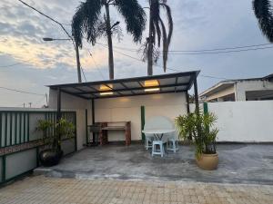 a small patio with a table and a desk at PD GREEN Homestay in Port Dickson