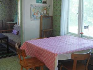 a room with a table with a pink checkered table cloth at 6 person holiday home in MöRLUNDA-By Traum in Fågelfors