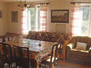 a living room with a table and a couch at 6 person holiday home in MöRLUNDA-By Traum in Fågelfors