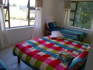 a bedroom with two beds in a room with windows at Lala Kahle in Sodwana Bay