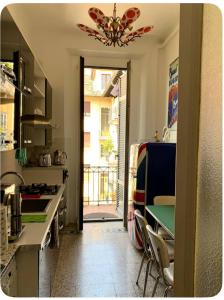 a kitchen with a table and a dining room at Elegant and beautiful apartment in Milan